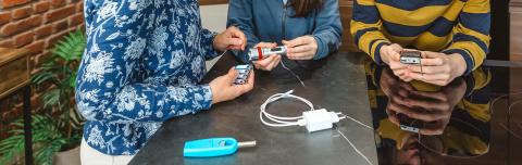 A family gathers batteries, flashlights and other items for a disaster kit